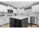 The updated kitchen has stainless steel appliances, a tile backsplash, and a central island at 19546 Forsythe Dr, Noblesville, IN 46060