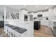 The modern eat-in kitchen features white cabinets, stainless appliances, and bar seating on the island at 19546 Forsythe Dr, Noblesville, IN 46060