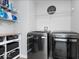 Well-organized laundry room with modern washer and dryer units and ample shelving at 19546 Forsythe Dr, Noblesville, IN 46060