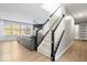 Living room with staircase, gray leather couch, and hardwood floors at 19546 Forsythe Dr, Noblesville, IN 46060