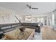 A well-lit living room features hardwood floors, a large sectional sofa, and access to the dining area at 19546 Forsythe Dr, Noblesville, IN 46060