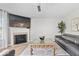 Comfortable living room featuring a fireplace, hardwood floors and a grey sectional couch at 19546 Forsythe Dr, Noblesville, IN 46060