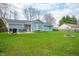 Well-maintained backyard featuring a patio, grill, fire pit, and ample green space, perfect for outdoor enjoyment at 20892 Overdorf Rd, Noblesville, IN 46062
