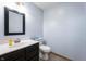 Bathroom featuring single sink vanity with dark wood cabinets, a toilet and vinyl flooring at 20892 Overdorf Rd, Noblesville, IN 46062