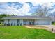Charming one-story home with blue siding, well-manicured lawn, and a welcoming front porch with rocking chairs at 20892 Overdorf Rd, Noblesville, IN 46062