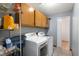 Functional laundry room equipped with modern washer, dryer, shelving, and convenient overhead storage at 20892 Overdorf Rd, Noblesville, IN 46062