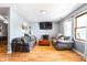 Comfortable living room featuring hardwood floors, neutral paint, ample seating, and a large window for natural light at 20892 Overdorf Rd, Noblesville, IN 46062