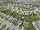Overhead view of a residential neighborhood featuring manicured lawns, mature trees, and winding streets at 24 W Pine Ridge Dr, Westfield, IN 46074