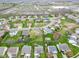 Bird's eye view of homes with green lawns, established trees, and a serene pond nearby at 24 W Pine Ridge Dr, Westfield, IN 46074