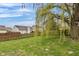 Well-manicured lawn and mature trees highlight this backyard with a wood fence at 24 W Pine Ridge Dr, Westfield, IN 46074
