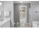 Hallway bathroom with a sink, doorway, and toilet paper dispenser at 24 W Pine Ridge Dr, Westfield, IN 46074