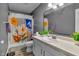 Bathroom with decorative shower curtain, updated lighting, and a neutral-colored sink and vanity at 24 W Pine Ridge Dr, Westfield, IN 46074