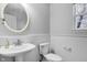 Bathroom with a pedestal sink, updated mirror, and bright natural light at 24 W Pine Ridge Dr, Westfield, IN 46074