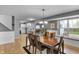 Open-concept dining area with hardwood floors, a large window, and seamless flow to the kitchen at 24 W Pine Ridge Dr, Westfield, IN 46074