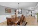 Spacious dining room featuring a large window, hardwood floors, and seamless flow to the kitchen at 24 W Pine Ridge Dr, Westfield, IN 46074