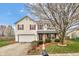 Charming two-story home with a well-manicured lawn, blossoming tree, and red-shuttered windows at 24 W Pine Ridge Dr, Westfield, IN 46074
