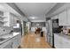 Open kitchen view into dining area with stainless steel appliances and hardwood floors at 24 W Pine Ridge Dr, Westfield, IN 46074