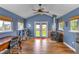 Cozy living room with a fireplace, wood floors, and large windows providing ample natural light at 24 W Pine Ridge Dr, Westfield, IN 46074