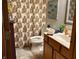 Bathroom with vanity, toilet, and patterned shower curtain, showcasing a functional and stylish design at 2509 Windsor Ct, Lebanon, IN 46052