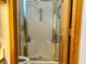 Bathroom featuring an enclosed shower area with glass doors and gold trim and a standard toilet at 2509 Windsor Ct, Lebanon, IN 46052