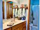 Bathroom vanity with wood cabinets, a shower stall, and decor shelf above the sink and faucet at 2509 Windsor Ct, Lebanon, IN 46052