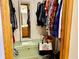 Walk-in closet with hanging clothes, storage chest, mirror, and handbag at 2509 Windsor Ct, Lebanon, IN 46052