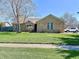 Charming single-story brick home featuring a well-manicured lawn and mature trees, creating a welcoming curb appeal at 2509 Windsor Ct, Lebanon, IN 46052
