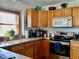 A well-equipped kitchen featuring wood cabinets, modern appliances, and ample counter space for cooking at 2509 Windsor Ct, Lebanon, IN 46052
