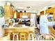 Cozy kitchen with wood cabinets, stainless steel appliances, and a convenient breakfast bar with seating at 2509 Windsor Ct, Lebanon, IN 46052