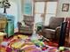 Comfortable living room with two recliners, colorful rug, end tables, and sunny window at 2509 Windsor Ct, Lebanon, IN 46052