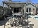 Backyard patio with dining set and pergola, ideal for outdoor gatherings, overlooks the sparkling in-ground pool at 2509 Windsor Ct, Lebanon, IN 46052