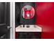Stylish powder room showcasing a black vanity and round mirror at 253 Provincial Ln # Apt D, Avon, IN 46123