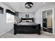Spacious bedroom with a large black bed, soft carpet and an adjacent bathroom at 253 Provincial Ln # Apt D, Avon, IN 46123
