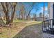 Backyard features a large tree and fenced in area with gravel on a sunny day at 2531 E Brookside Ave, Indianapolis, IN 46218