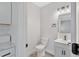 Updated bathroom featuring a modern vanity, stylish lighting, and a toilet at 2531 E Brookside Ave, Indianapolis, IN 46218