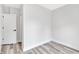 A bright bedroom with white walls and baseboards and grey vinyl floors at 2531 E Brookside Ave, Indianapolis, IN 46218