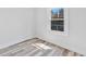 Bright bedroom with a window letting in natural light and modern grey vinyl flooring at 2531 E Brookside Ave, Indianapolis, IN 46218