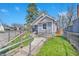 View of light gray home with a chain-link fence and fresh green grass at 2531 E Brookside Ave, Indianapolis, IN 46218