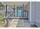Inviting front porch with gray siding and a blue front door at 2531 E Brookside Ave, Indianapolis, IN 46218