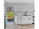 Bright kitchen features white cabinetry, stainless steel appliances, and backyard access at 2531 E Brookside Ave, Indianapolis, IN 46218