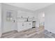 Bright kitchen features white cabinets, stainless steel appliances, and wood-look flooring at 2531 E Brookside Ave, Indianapolis, IN 46218