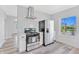 Modern kitchen with stainless steel appliances, white subway tiles and wood-look floors at 2531 E Brookside Ave, Indianapolis, IN 46218