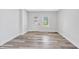 Bright living room with wood-look flooring, fresh white paint, and natural light at 2531 E Brookside Ave, Indianapolis, IN 46218