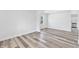 Open living room with wood-look floors, neutral paint, and archway to kitchen at 2531 E Brookside Ave, Indianapolis, IN 46218