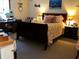 Comfortable bedroom with a wooden bed frame, warm lighting, and decor at 2575 S Indianapolis Rd, Lebanon, IN 46052