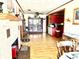 An open-concept living room boasts laminate floors, a fireplace, and bright kitchen view at 2575 S Indianapolis Rd, Lebanon, IN 46052