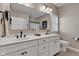 Bright bathroom with double vanity, white cabinetry, framed mirror, and natural light at 2601 Viceroy Ln, Lebanon, IN 46052