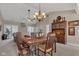 Inviting dining room showcases a chandelier, hardwood floors, and a view into the living area at 2601 Viceroy Ln, Lebanon, IN 46052