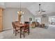 Open concept dining area features vaulted ceilings, a ceiling fan, and a view into the living area at 2601 Viceroy Ln, Lebanon, IN 46052