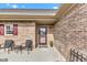 Charming brick home features a cozy front porch with seating and a beautifully landscaped yard at 2601 Viceroy Ln, Lebanon, IN 46052
